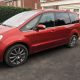 Car at residential driveway after bodywork repair
